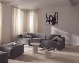 Nowoczesny salon z szarą sofą i pufami, inspiracja jak uzyskać kolor grafitowy w aranżacji.