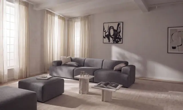 Nowoczesny salon z szarą sofą i pufami, inspiracja jak uzyskać kolor grafitowy w aranżacji.
